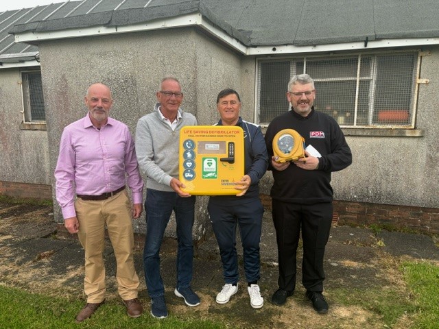 Builders merchant donates defibrillator to East Ayrshire football team